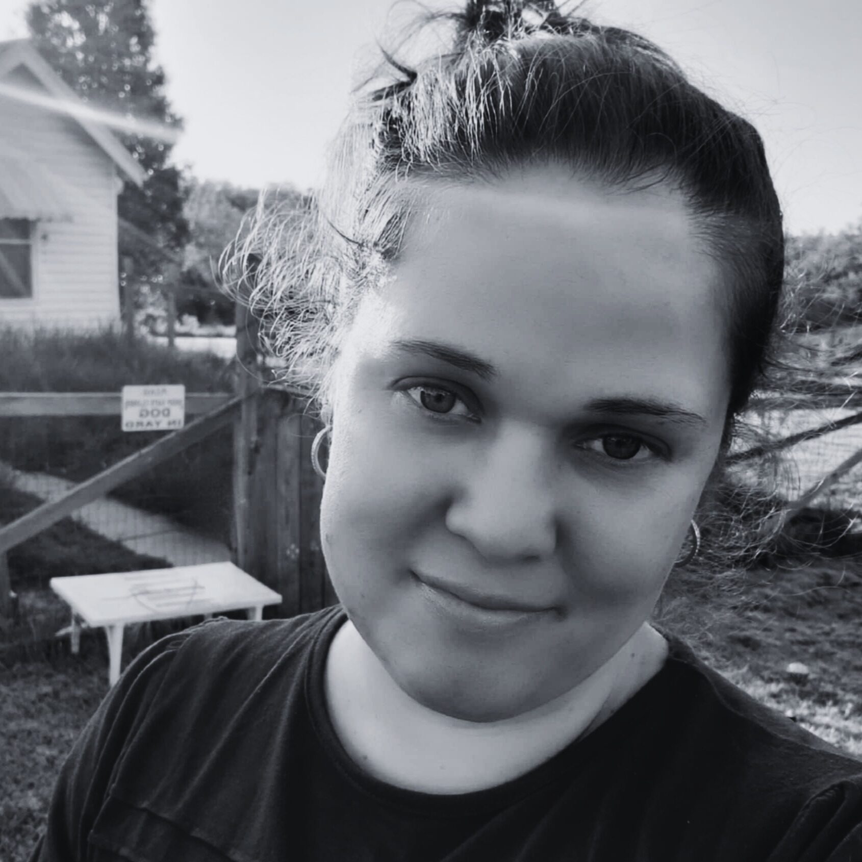 Margo, a staff member at The Warehouse community recreation center, smiling outdoors